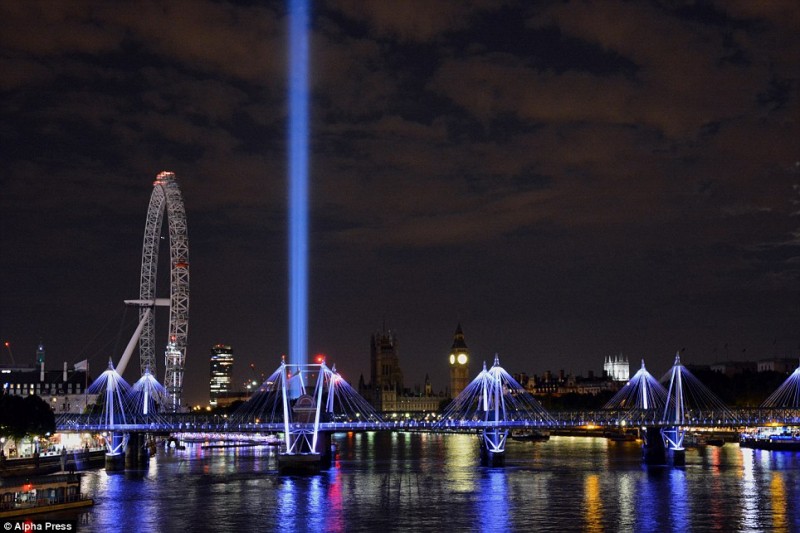A single beam pierces the sky as the lights go out across Britain: Tributes to the fallen a century since World War One was declared  13