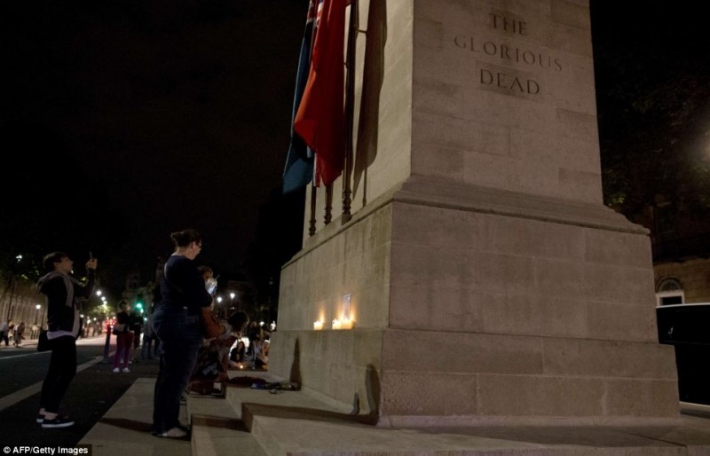 A single beam pierces the sky as the lights go out across Britain: Tributes to the fallen a century since World War One was declared  25