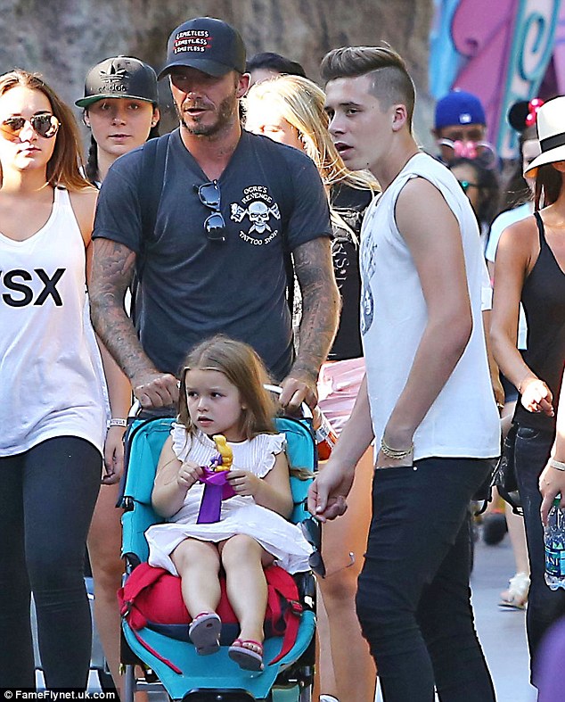 A princess in her element! Harper looks thrilled as David and Victoria Beckham take her and brothers Brooklyn, Romeo and Cruz to Disneyland 1